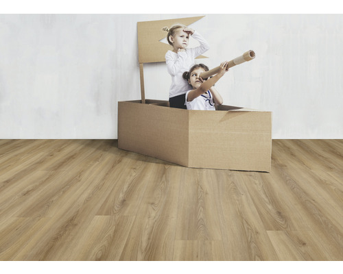 Dvě děti si hrají v kartonové krabici na laminátové podlaze.