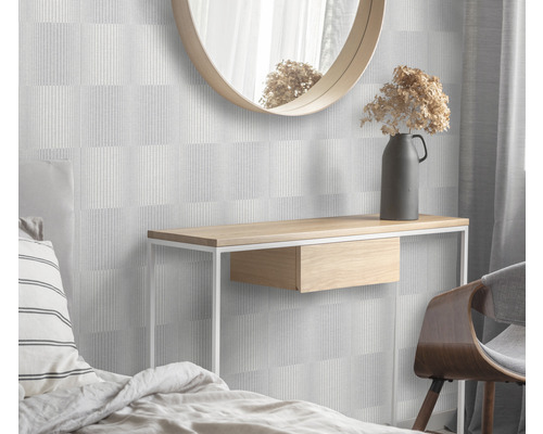 Ložnice s geometrickou tapetou, konzolí, zrcadlem a dekorací