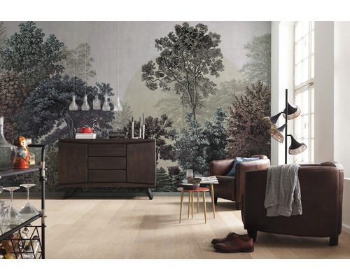 Obývací pokoj s fototapetou s motivem lesa, příborníkem a koženými křesly.