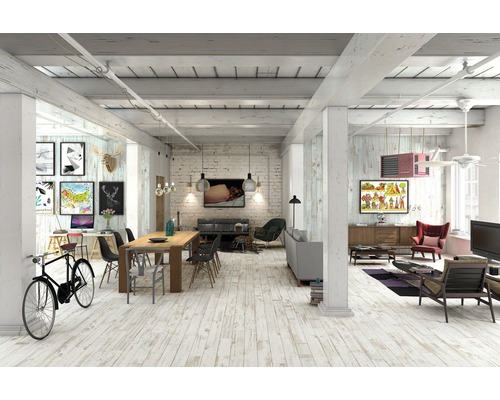 Světlý obývací pokoj s dřevěnou podlahou, jídelním stolem, pohovkami a uměleckými díly