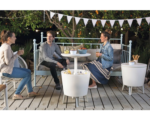 Tři lidé sedí na terase s chladicími boxy a odkládacími stolky