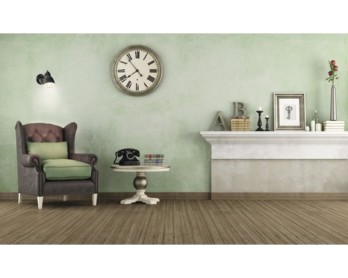 Obývací pokoj s křeslem, hodinami a dekorací na římse krbu