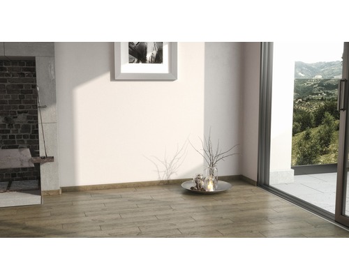 Světlá místnost s krbem, dřevěnou podlahou a terasovými dveřmi s výhledem do zeleně.