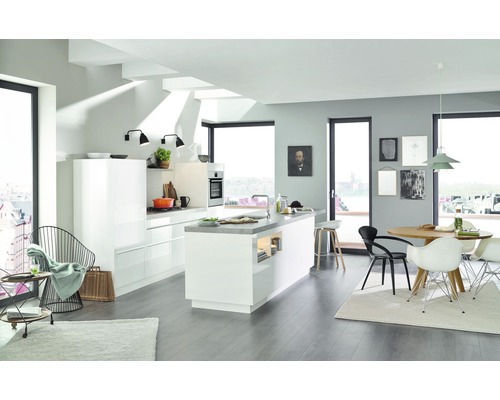 Světlá kuchyně s kuchyňským ostrůvkem, jídelním stolem a židlemi v moderním designu.