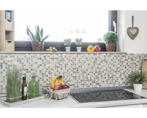 Kuchyňská scéna s mozaikovou stěnou, rostlinami a ovocem