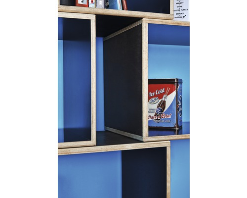 Detailní pohled na dřevěný regál s úložnými přihrádkami a dekorativní kovovou dózou