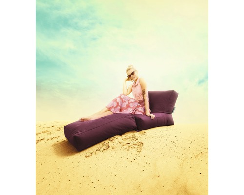Žena sedí venku na fialovém sedacím vaku
