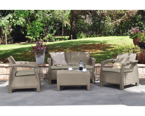 Zahradní nábytek se dvěma křesly, pohovkou a stolem na terase v zahradě.