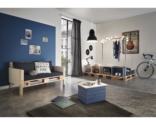 Obývací pokoj s nábytkem z palet, včetně pohovky, stolu a věšáku na oblečení