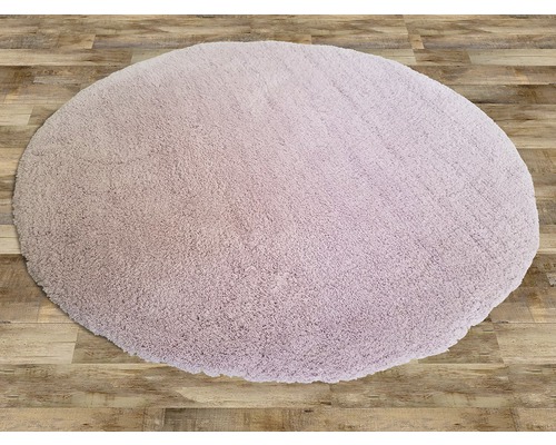 Kulatý, všívaný koberec na dřevěné podlaze