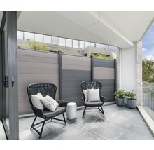 Balkon se dvěma židlemi, polštáře, malý stolek, rostliny a plot