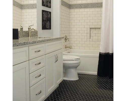 Koupelna s bílým umyvadlem, toaletou, vanou a šestihrannou dlažbou