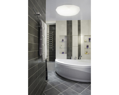 Moderní koupelna s vanou, obklady a držákem na ručníky