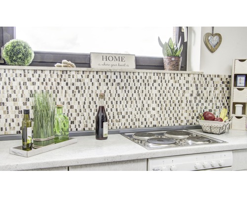 Kuchyňská scéna s mozaikovými obklady, dekoracemi a kuchyňským náčiním na pracovní ploše