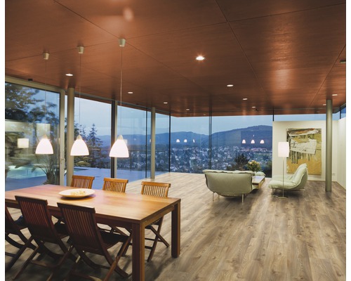 Světlá místnost s jídelním stolem, posezením a velkými okny