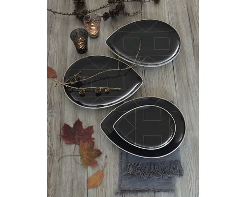 Dekorativní uspořádání s černými talíři s geometrickými vzory