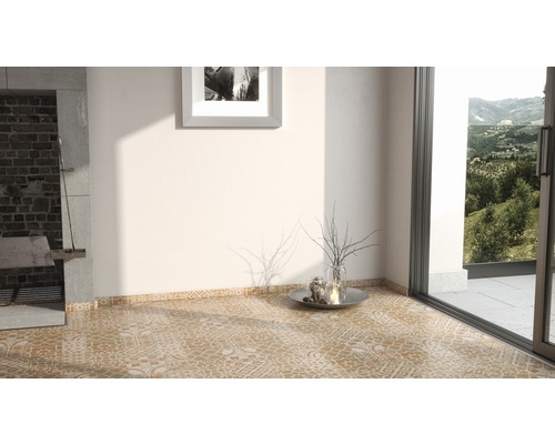 Interiér s vzorovanou dlažbou, krbem a výhledem do zeleně