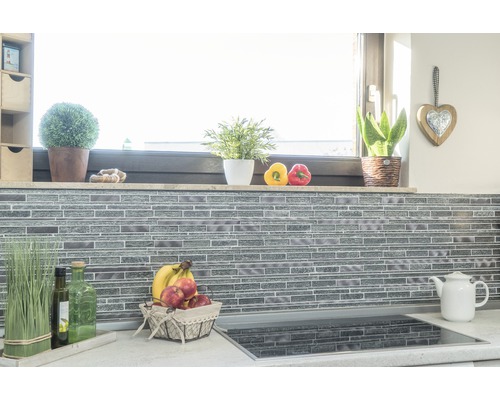 Kuchyňská scéna s mozaikovou obkladovou stěnou, dekorací a potravinami