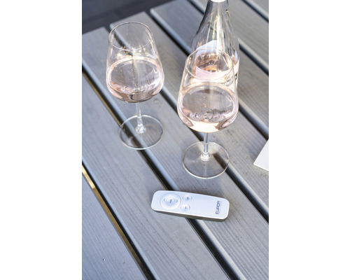 Dvě sklenice na víno a láhev vína s dálkovým ovládáním na dřevěném stole