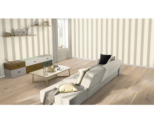 Světlý obývací pokoj s pruhovanou tapetou, pohovkou, stolem a komodou