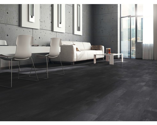 Moderní obývací pokoj s tmavou laminátovou podlahou, pohovkou a betonovou stěnou