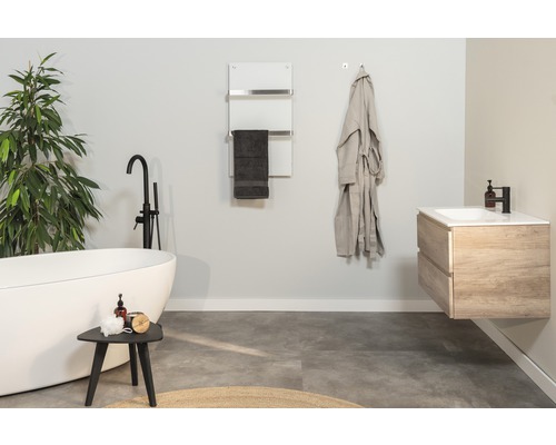 Moderní koupelna s volně stojící vanou, umyvadlem, ohřívačem ručníků a županem