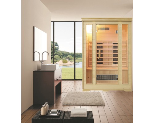 Moderní koupelnová scéna s infra saunou, umyvadlem a výhledem do zeleně.