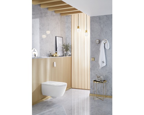 Moderní koupelna se závěsným WC, umyvadlem a dekorativními prvky pro stylové prostředí.