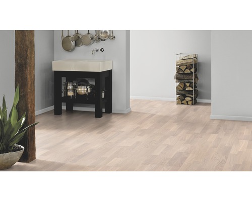 Kuchyňská scéna se světlou dřevěnou podlahou, umyvadlem a hromadou dřeva