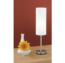 Dekorativní stolní lampa s vázou a květinou na stole