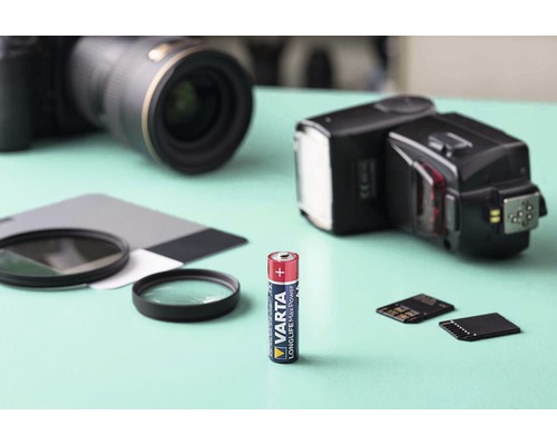 Baterie Varta s fotoaparáty a fotografickým příslušenstvím v pozadí