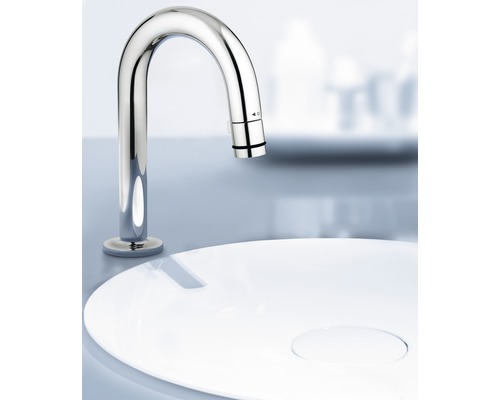 Umyvadlová baterie z kovu nad bílým umyvadlem