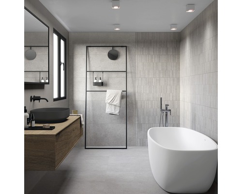 Moderní koupelna s volně stojící vanou, umyvadlem a šedými obklady