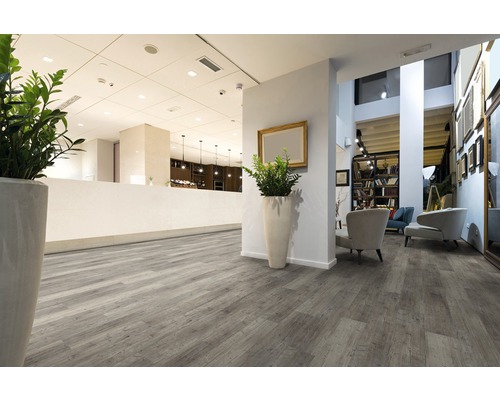 Interiér s šedou dřevěnou podlahou.