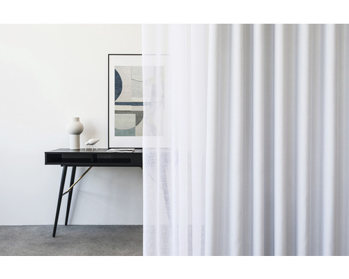 Scéna s bílým závěsem, psacím stolem, grafikou a dekorací