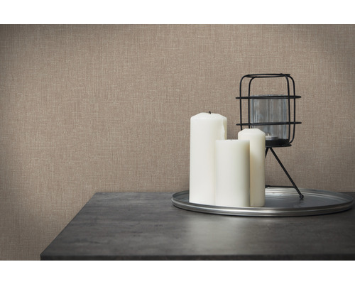 Detailní záběr stěny s textilní tapetou v kombinaci se svíčkami a lucernou