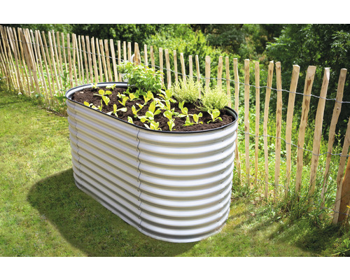 Kovový vyvýšený záhon s rostlinami na zahradě