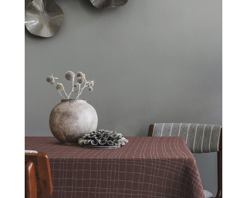 Prostřený stůl s kostkovaným ubrusem, vázou a dekorací