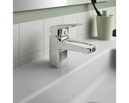 Lesklá umyvadlová baterie na umyvadle v koupelně.