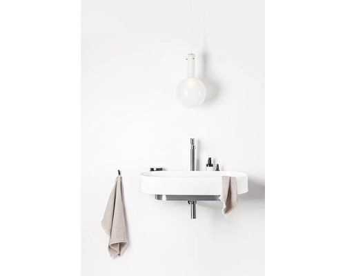 Moderní koupelna s umyvadlem na desku, baterií, ručníky a závěsným svítidlem