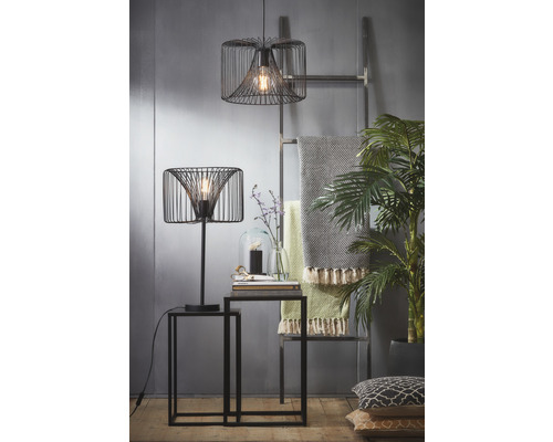 Dekorativní interiér se stolní lampou, závěsnou lampou, dvěma odkládacími stolky, žebříkem, dekou a pokojovými rostlinami.