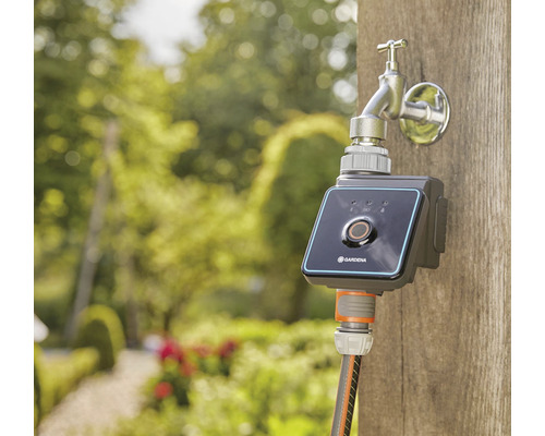Kohoutek Gardena se zavlažovacím systémem na dřevěném sloupku