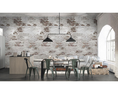 Světlá místnost s jídelním stolem, židlemi a cihlovou tapetou ve vintage stylu.
