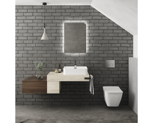 Moderní koupelna s umyvadlem, zrcadlem s osvětlením a závěsným klozetem před cihlovou zdí