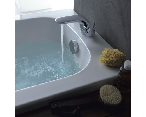 Koupelnová scéna s naplněnou vanou, vodovodní baterií a koupelnovými potřebami