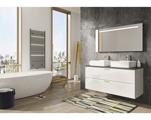 Moderní koupelna s vanou, umyvadlovou skříňkou se dvěma umyvadly, osvětleným zrcadlem a ohřívačem ručníků