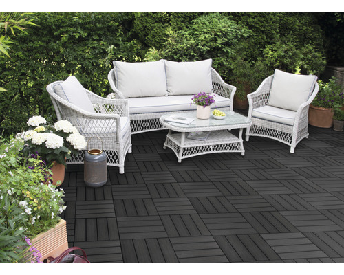 Terasa s tmavými terasovými dlaždicemi a ratanovým posezením v zahradě