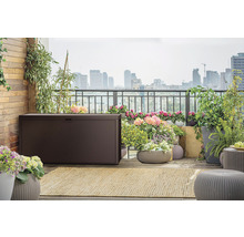 Exteriér terasy s hnědým úložným boxem, rostlinami a výhledem na město