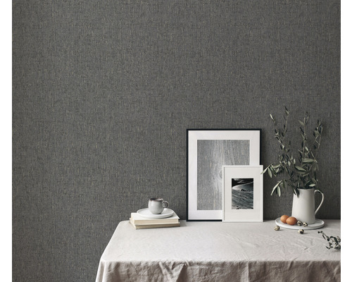 Detailní záběr strukturované šedé tapety v interiéru s dekorací stolu