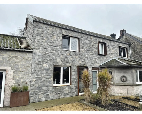 Vnější pohled na dům s kamenným zdivem a okny